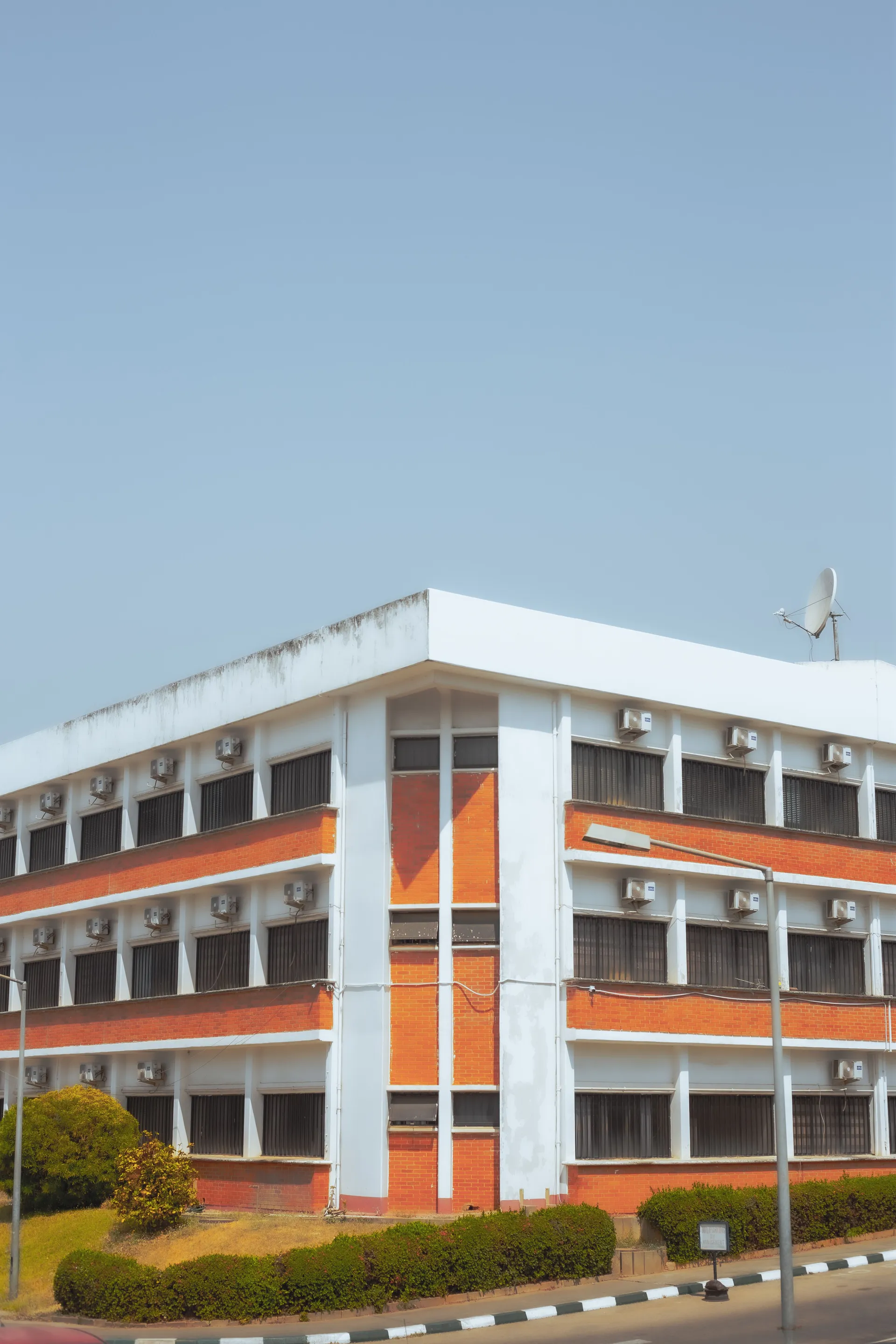 A white and orange school building under a clear sky
