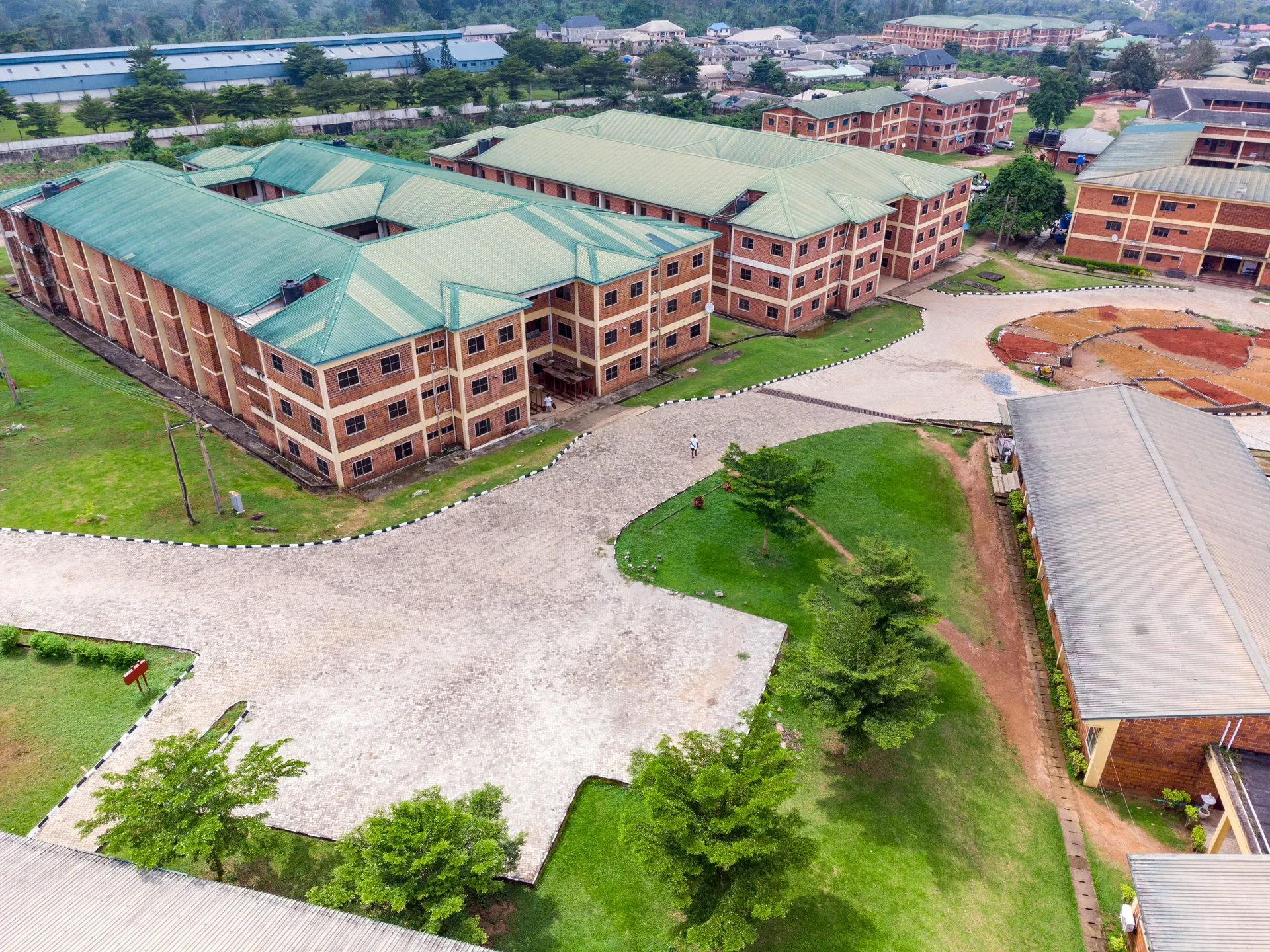 An aerial view of classroom blocks and paved grounds on a school campus