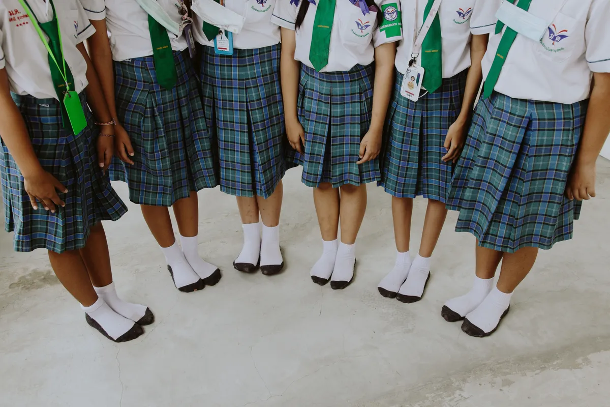 Students in uniform lined up in the school yard